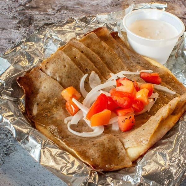 Stavro's Pizza House IV gyro meat with diced tomatoes, onions, and a side of tzatziki sauce.