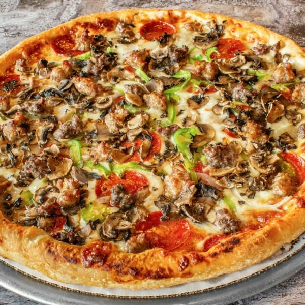 Stavro's Pizza House IV's fully loaded pizza with pepperoni, sausage, mushrooms, and green peppers.